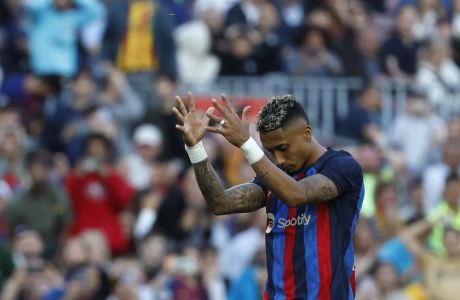 Barcelona's Raphinha reacts after a missed scoring opportunity during a Spanish La Liga soccer match between Barcelona and Osasuna at the Camp Nou stadium in Barcelona, Spain, Tuesday, May 2, 2023. (AP Photo/Joan Monfort)