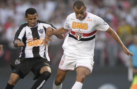 Sao Paulo FC' s Rivaldo, right, is challenged by Atletico Mineiro's Serginho, during a Brazilian soccer league match in Sao Paulo, Brazil, Wednesday, Sept. 7, 2011. (AP Photo/Andre Penner)