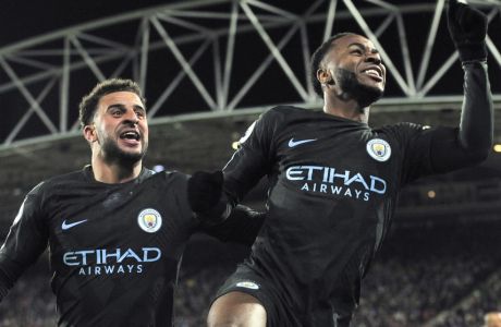 Manchester City's Raheem Sterling, right, celebrates with teammate Kyle Walker after scoring during the English Premier League soccer match between Huddersfield Town and Manchester City at John Smith's stadium, in Huddersfield, England, Sunday, Nov. 26, 2017. (AP Photo/Rui Vieira)