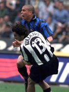 Brazilian soccer ace Ronaldo of Internazionale of Milan, top, is tackled in the goal area by Mark Iuliano of Turin during the Juventus vs Inter First Division soccer match in Turin's Delle Alpi stadium, Sunday April 26, 1998. Referee Piero Ceccarini did not award a penalty kick for Iuliano's controversial tackle, sparking off  tense discussions amongst Inter's players and coaches. Juventus won 1-0. (AP Photo/Claudio Miano)