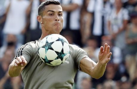 FILE - In this Sunday, Aug. 12, 2018 file photo Cristiano Ronaldo controls the ball during a friendly match between the Juventus A and B teams, in Villar Perosa, northern Italy. The eyes of the footballing world will be on Verona where Cristiano Ronaldo is expected to make his Serie A debut when Chievo Verona hosts Juventus. Ronaldo has moved from Real Madrid to Juventus in a Serie A record 112 million-euro ($131.5 million) deal and is expected to make the Bianconeri even more dominant in Serie A. Carlo Ancelotti is back in Italian football after a nine-year absence and the new Napoli coach is keen to ensure that doesnt happen. (AP Photo/Antonio Calanni, File)