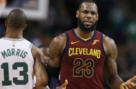 Cleveland Cavaliers forward LeBron James (23) reacts next to Boston Celtics forward Marcus Morris (13) during the third quarter of Game 1 of the NBA basketball Eastern Conference Finals, Sunday, May 13, 2018, in Boston. (AP Photo/Michael Dwyer)