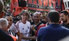 AC Milan's Riccardo Montolivo is flanked by supporters prior to the team training at the Milanello sport center, in Carnago, Italy, Wednesday, July 5, 2017. (AP Photo/Luca Bruno)