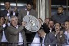 Bayern's head coach Carlo Ancelotti lifts the trophy as his team celebrate on the balcony of the town hall at Marienplatz square after winning the 27th Bundesliga title at the German first division Bundesliga soccer match between FC Bayern Munich and SC Freiburg at the Allianz Arena stadium in Munich, Germany, Saturday, May 20, 2017. (AP Photo/Matthias Schrader)