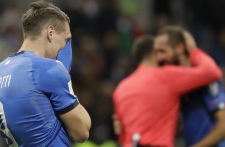 Italy's Andrea Belotti cries as Referee Antonio Mateu Lahoz of Spain comforts Italy's Giorgio Chiellini, right, after Italy failed to qualify in the World Cup qualifying play-off second leg soccer match between Italy and Sweden, at the Milan San Siro stadium, Italy, Monday, Nov. 13, 2017. (AP Photo/Luca Bruno)