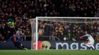 Barcelona defender Gerard Pique, left, scores his side's fourth goal during the Champions League round of 16, 2nd leg, soccer match between FC Barcelona and Olympique Lyon at the Camp Nou stadium in Barcelona, Spain, Wednesday, March 13, 2019. (AP Photo/Manu Fernandez)