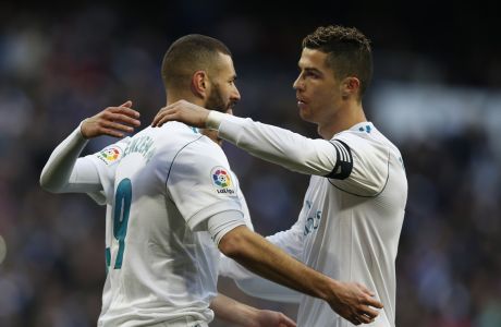 Real Madrid's Karim Benzema, left, celebrates with teammate Cristiano Ronaldo after scoring their side's fourth goal against Alaves during the Spanish La Liga soccer match between Real Madrid and Alaves at the Santiago Bernabeu stadium in Madrid, Saturday, Feb. 24, 2018. Ronaldo scored twice and Benzema once in Real Madrid's 4-0 victory. (AP Photo/Francisco Seco)