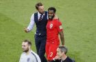 England head coach Gareth Southgate, center left, leaves the field with England's Danny Rose after defeating Colombia in a penalty shootout at the end of the round of 16 match between Colombia and England at the 2018 soccer World Cup in the Spartak Stadium, in Moscow, Russia, Tuesday, July 3, 2018. (AP Photo/Antonio Calanni)