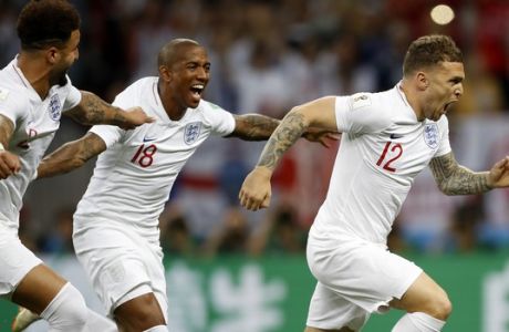 England's Kieran Trippier, right, celebrates with teammates Ashley Young, center, and Kyle Walker, left, after scoring the opening goal during the semifinal match between Croatia and England at the 2018 soccer World Cup in the Luzhniki Stadium in Moscow, Russia, Wednesday, July 11, 2018. (AP Photo/Francisco Seco)