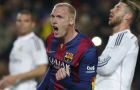 Barcelona's Jeremy Mathieu clenches his fist after scoring his side's first goal as Real Madrid's Sergio Ramos, right, fails to stop him during a Spanish La Liga soccer match between FC Barcelona and Real Madrid at Camp Nou stadium, in Barcelona, Spain, Sunday, March 22, 2015. (AP Photo/Emilio Morenatti)
