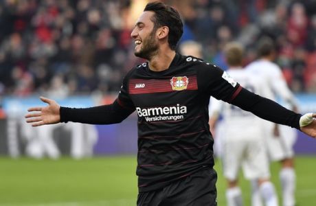 FILE - In this file photo dated Sunday, Jan. 22, 2017, Leverkusen's Hakan Calhanoglu celebrates after scoring from a penalty during the German Bundesliga soccer match between Bayer Leverkusen and Hertha BSC Berlin in Leverkusen, Germany.  22-year old Bayer Leverkusen midfielder Hakan Calhanoglu will serve a four-month ban and pay a fine imposed by FIFA for breach of contract, the Court of Arbitration for Sport ruled Thursday Feb. 2, 2017. (AP Photo/Martin Meissner, FILE)