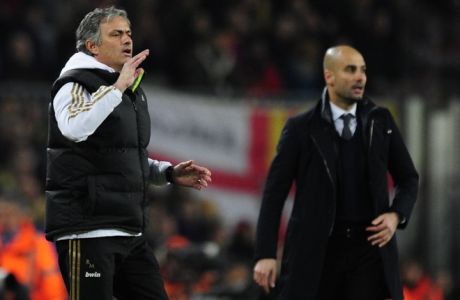 Real Madrid's Portuguese coach Jose Mourinho (L) gestures in front of Barcelona's coach Josep Guardiola (R) after Real Madrid's defender Sergio Ramos received a red card during the second leg of the Spanish Cup quarter-final "El clasico" football match Barcelona vs Real Madrid at the Camp Nou stadium in Barcelona on January 25, 2012.  AFP PHOTO/JAVIER SORIANO (Photo credit should read JAVIER SORIANO/AFP/Getty Images)
