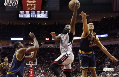 Houston Rockets' James Harden (13) goes up for a shot as Cleveland Cavaliers' Richard Jefferson (24) and Tristan Thompson, left, defend during the first quarter of an NBA basketball game Sunday, March 12, 2017, in Houston. (AP Photo/David J. Phillip)