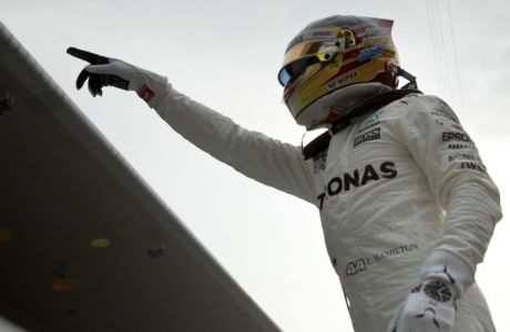 Mercedes driver Lewis Hamilton of Britain points to the fans after qualifying in pole position for the Chinese Formula One Grand Prix at the Shanghai International Circuit in Shanghai, China, Saturday, April 8, 2017. (AP Photo/Mark Schiefelbein)