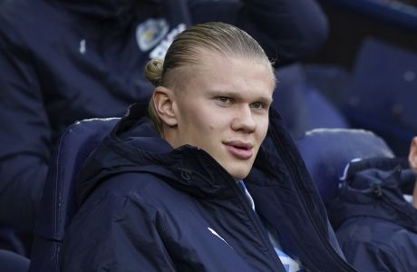 Manchester City's Erling Haaland sits on the bench at the start of the English Premier League soccer match between Manchester City and Fulham at Etihad stadium in Manchester, England, Saturday, Nov. 5, 2022. (AP Photo/Dave Thompson)