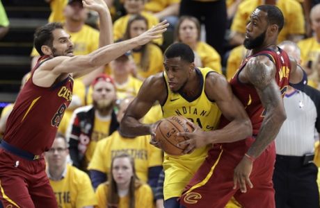 Indiana Pacers' Thaddeus Young, center, tries to squeeze between Cleveland Cavaliers' Jose Calderon, left, and LeBron James during the first half of Game 6 of a first-round NBA basketball playoff series, Friday, April 27, 2018, in Indianapolis. (AP Photo/Darron Cummings)