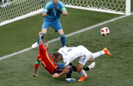 Russia's Sergei Ignashevich, front right, scores an own goal during the round of 16 match between Spain and Russia at the 2018 soccer World Cup at the Luzhniki Stadium in Moscow, Russia, Sunday, July 1, 2018. (AP Photo/Vincent Michel)