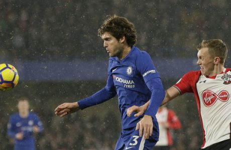 Chelsea's Marcos Alonso, left, competes for the ball with Southampton's James Ward-Prowse during the English Premier League soccer match between Chelsea and Southampton at Stamford Bridge in London, Saturday Dec. 16, 2017. (AP Photo/Tim Ireland)