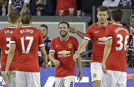 Manchester United forward Juan Mata (8) is greeted by his teammates after scoring a goal during the first half of an International Champions Cup soccer match against the San Jose Earthquakes on Tuesday, July 21, 2015, in San Jose, Calif. (AP Photo/Eric Risberg)