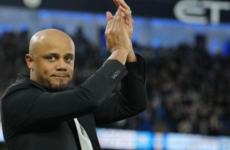 Burnley's head coach Vincent Kompany applauds before the English FA Cup quarter final soccer match between Manchester City and Burnley at the Etihad stadium in Manchester, England, Saturday, March 18, 2023. (AP Photo/Jon Super)