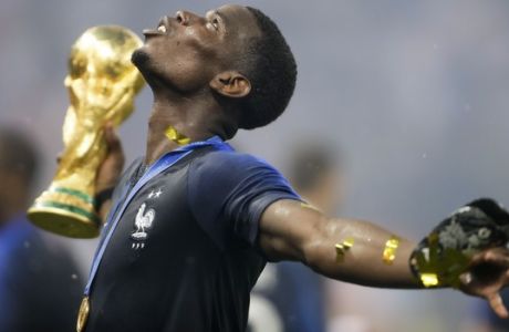France's Paul Pogba celebrates with the trophy after the final match between France and Croatia at the 2018 soccer World Cup in the Luzhniki Stadium in Moscow, Russia, Sunday, July 15, 2018. (AP Photo/Natacha Pisarenko)