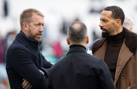 Chelsea's head coach Graham Potter, left, talks with former Manchester United player Rio Ferdinand, right, ahead the English Premier League soccer match between West Ham United and Chelsea in London, Saturday, Feb. 11, 2023. (AP Photo/David Cliff)