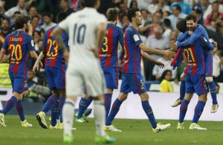 Barcelona's Lionel Messi, right, celebrates with teammates after scoring the winning goal during a Spanish La Liga soccer match between Real Madrid and Barcelona, dubbed 'el clasico', at the Santiago Bernabeu stadium in Madrid, Spain, Sunday, April 23, 2017. Barcelona won 3-2. (AP Photo/Francisco Seco)