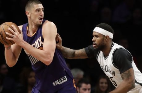 Phoenix Suns' Alex Len, left, is defended by Brooklyn Nets' Trevor Booker (35) during the first half of an NBA basketball game Thursday, March 23, 2017, in New York. (AP Photo/Frank Franklin II)