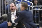 Orlando Magic head coach Frank Vogel, left, is restrained by assistant coach Chad Forcier while arguing a call by an official during the first half of an NBA basketball game against the Los Angeles Clippers, Wednesday, Dec. 13, 2017, in Orlando, Fla. Vogel received a technical foul call for his actions. (AP Photo/Phelan M. Ebenhack)