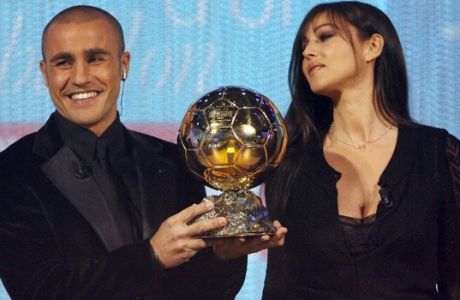 Italy's World Cup-winning captain Fabio Cannavaro is congratuled by actress Monica Bellucci after being awarded the 2006 'Ballon d'Or' (Golden Ball), for best football player of the year, 27 November 2006 in Paris. AFP PHOTO FRANCK FIFE / AFP PHOTO / FRANCK FIFE