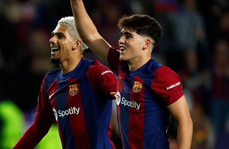 Barcelona's Pau Cubarsi, right, and Barcelona's Ronald Araujo celebrate after the Champions League, round of 16, second leg soccer match between FC Barcelona and SSC Napoli at the Olympic Stadium in Barcelona, Spain, Tuesday, March 12, 2024. (AP Photo/Joan Monfort)