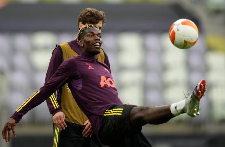 Manchester United's Paul Pogba controls the ball during a training session in Gdansk, Poland, Tuesday May 25, 2021 ahead of the Europa League final soccer match between Manchester United and Villarreal. (AP Photo/Michael Sohn)