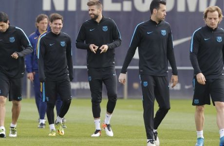 From left, FC Barcelona's Luis Suarez, Lionel Messi, Gerard Pique, Sergio Busquet, and Ivan Rakitic attend a training session at the Sports Center FC Barcelona Joan Gamper in San Joan Despi, Spain, Monday, April 4, 2016.  FC Barcelona will play against Atletico Madrid in a Champions League soccer match on Tuesday April 5. (AP Photo/Manu Fernandez)