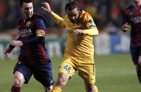 Barcelona's Lionel Messi fights for the ball with APOEL's Efstathios Aloneftis during a Champions League Group F soccer match between APOEL and FC Barcelona at GSP stadium, in Nicosia, Cyprus, Tuesday, Nov. 25, 2014. (AP Photo/Petros Karadjias)