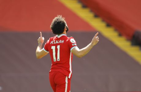 Liverpool's Mohamed Salah celebrates after scoring his side's opening goal during the English Premier League soccer match between Liverpool and Newcastle United at Anfield stadium in Liverpool, England, Saturday, April 24, 2021. (David Klein, Pool via AP)