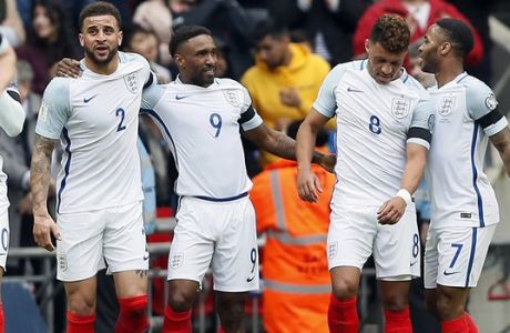 England's scorer Jermain Defoe, 3rd right, and his teammates celebrate the opening goal during the World Cup Group F qualifying soccer match between England and Lithuania at the Wembley Stadium in London, Great Britain, Sunday, March 26, 2017. (AP Photo/Kirsty Wigglesworth)