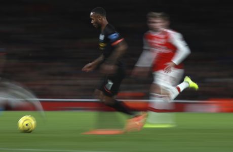 In this photo taken with slow shutter speed, Manchester City's Raheem Sterling, left, runs with the ball during the English Premier League soccer match between Arsenal and Manchester City, at the Emirates Stadium in London, Sunday, Dec. 15, 2019. (AP Photo/Ian Walton)