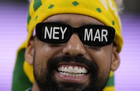 A Brazil soccer fan wears glasses with a name of Brazil's Neymar prior to the start of the World Cup quarterfinal soccer match between Croatia and Brazil, at the Education City Stadium in Al Rayyan, Qatar, Friday, Dec. 9, 2022. (AP Photo/Darko Bandic)