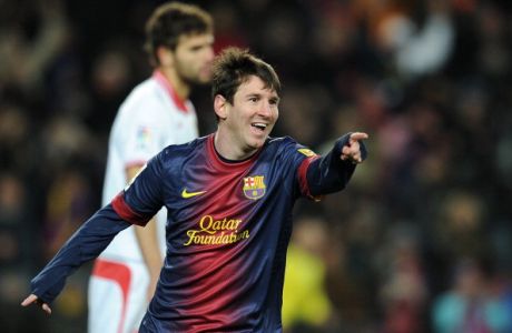 Barcelona's Argentinian forward Lionel Messi celebrates after scoring during the Spanish league football match FC Barcelona vs Sevila FC at the Camp Nou stadium in Barcelona on February 23, 2013. AFP PHOTO / LLUIS GENE        (Photo credit should read LLUIS GENE/AFP/Getty Images)