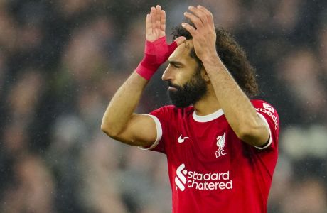 Liverpool's Mohamed Salah celebrates at the end of the English Premier League soccer match between Liverpool and Newcastle, at Anfield stadium in Liverpool, England, Monday, Jan. 1, 2024. (AP Photo/Jon Super)