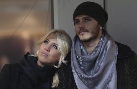 Inter Milan forward Mauro Icardi, of Argentina, is flanked by Argentine model Wanda Nara as they sit in the stands prior to a Serie A soccer match between Inter Milan and Chievo, at the San Siro stadium in Milan, Italy, Monday, Jan.13, 2014. (AP Photo/Luca Bruno)

