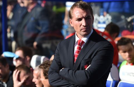 Liverpool manager Brendan Rodgers stands on the touchline ahead of their English Premier League soccer match against Queens Park Rangers at Loftus Road, London, Sunday, Oct. 19, 2014. (AP Photo/Tim Ireland)