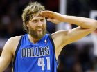 Dallas Mavericks power forward Dirk Nowitzki (41) celebrates after scoring his 25,000 career point during the first half of an NBA basketball game against the New Orleans Hornets in New Orleans, Sunday, April 14, 2013. (AP Photo/Jonathan Bachman)