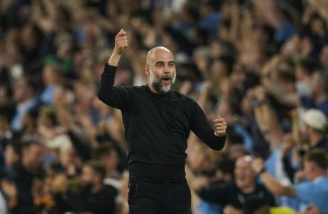 Manchester City's head coach Pep Guardiola celebrates after Manchester City's Julian Alvarez scoring his side's opening goal during the English Premier League soccer match between Manchester City and Newcastle at the Etihad stadium in Manchester, England, Saturday, Aug. 19, 2023. (AP Photo/Dave Thompson)