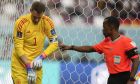 A linesman checking Germany's goalkeeper Manuel Neuer putting his gloves on during the World Cup group E soccer match between Germany and Japan, at the Khalifa International Stadium in Doha, Qatar, Wednesday, Nov. 23, 2022. (AP Photo/Matthias Schrader)