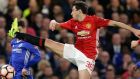Manchester United's Matteo Darmian kicks at the ball as Chelsea's Eden Hazard watches during the English FA Cup quarterfinal soccer match between Chelsea and Manchester United at Stamford Bridge stadium in London, Monday, March 13, 2017 (AP Photo/Alastair Grant)