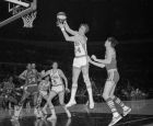 Rick Barry (24) of the New York Nets takes a rebound away from Bob Netolicky, left, of the Indiana Pacers in first period action at New York's Madison Square Garden, Dec. 10, 1970.  Pacers defeated the Nets in the ABA Garden debut.  (AP Photo/John Lent)