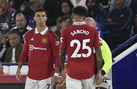 Manchester United's Cristiano Ronaldo, left, waits to enter the pitch as Manchester United's head coach Erik ten Hag gives directions during the English Premier League soccer match between Leicester City and Manchester United at King Power stadium in Leicester, England, Thursday, Sept. 1, 2022. (AP Photo/Rui Vieira)