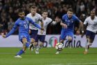 Italy's Lorenzo Insigne scores on a penalty during the international friendly soccer match between England and Italy at the Wembley Stadium in London, Tuesday, March 27, 2018. (AP Photo/Kirsty Wigglesworth)