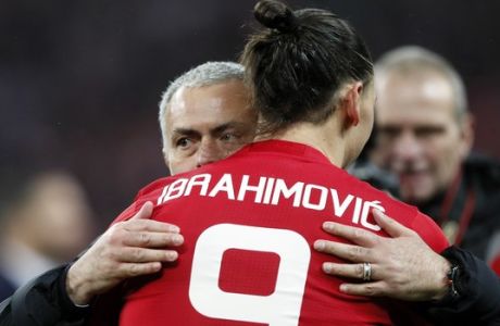 United manager Jose Mourinho, left, hugs United's Zlatan Ibrahimovic after they won the English League Cup final soccer match between Manchester United and Southampton FC at Wembley stadium in London, Sunday, Feb. 26, 2017. (AP Photo/Kirsty Wigglesworth)
